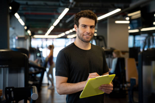 istock Happy personal trainer working at a gym 1222244384