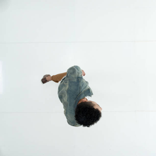 istock Male dancing in front of white background wearing denim jacket 1222244753