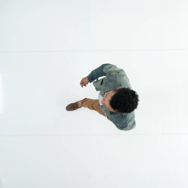 istock Male walking in front of white background wearing denim jacket 1222244823
