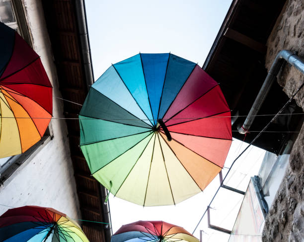 Street decorated with coloured and open umbrellas.