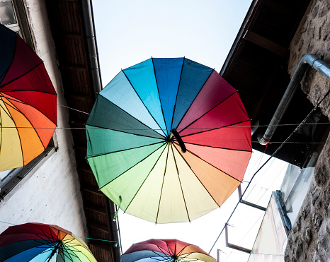 Street decorated with coloured and open umbrellas.
