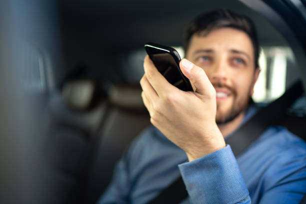 istock Businessman talking on mobile phone at passenger seat inside a car 1222245636