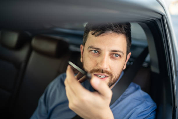istock Businessman talking on mobile phone at passenger seat inside a car 1222245646