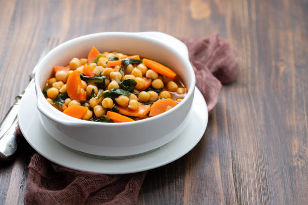 istock chick-pea with carrot and spinach on white bowl on brown wooden backgeound 1222246249