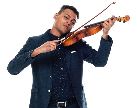 Front view of aged 20-29 years old with black hair african-american ethnicity young male musician standing in front of white background wearing business casual who is laughing and holding musical instrument