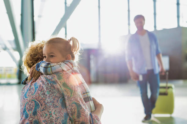 Portrait of woman reuniting with her daughter in airport Portrait of woman reuniting with her daughter in airport airport hug stock pictures, royalty-free photos & images