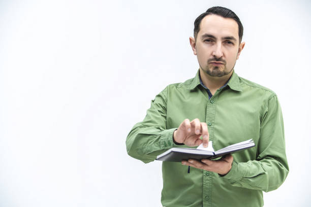 istock Excausted man tearing out a page from his personal organizer with schedule and plans. 1222250265