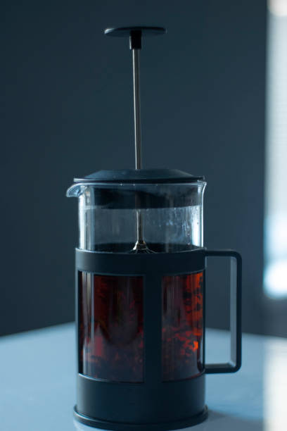 istock french press black tea on a white table and grey background 1222251139