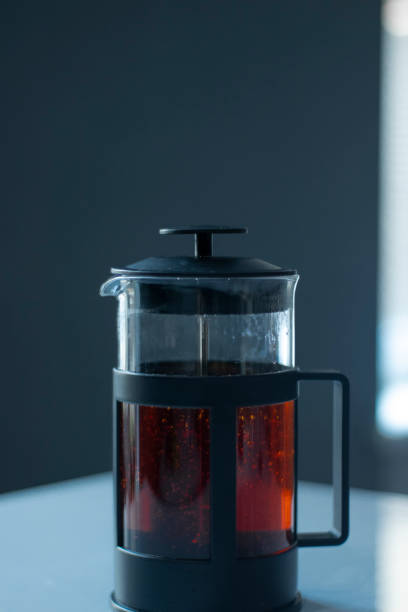 istock french press black tea on a white table and grey background 1222251298
