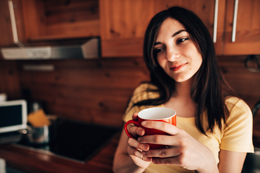 teenager drinking a coffee at home during the quarantine