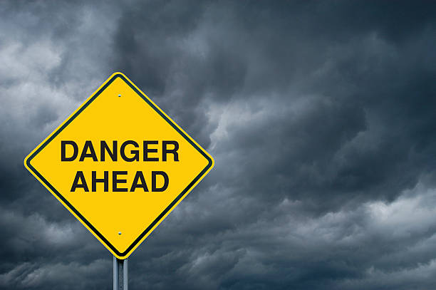 istock Caution Sign in Front of Storm Clouds 122225251