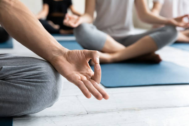 istock Yogi sit in lotus pose closeup focus on folded fingers 1222252808