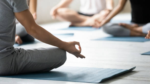 istock Yoga coach and session participants meditating close up concept image 1222252831