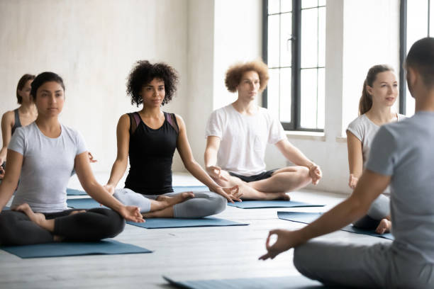 istock Group of diverse people sitting cross-legged do meditation practice 1222252834