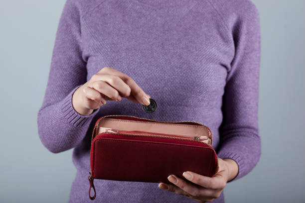 istock woman hand coin with wallet 1222254470