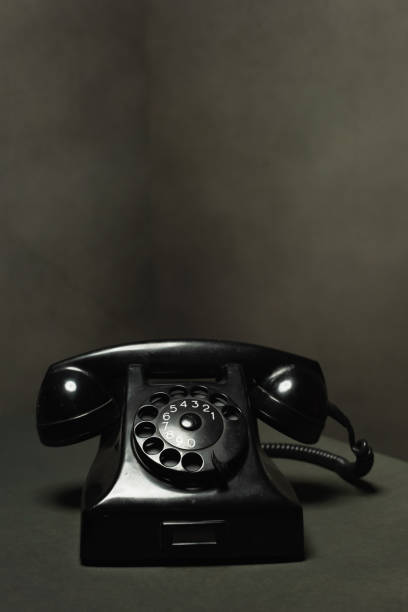 istock Vintage black telephone in gray empty room. 1222255586