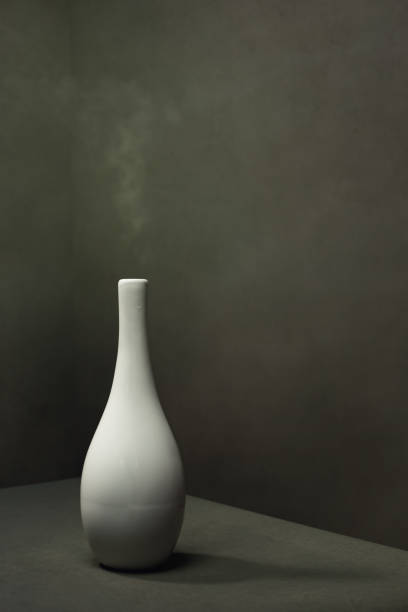 istock White pottery vase with smoke in gray empty space. 1222255627