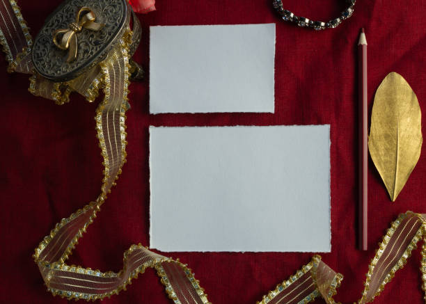 istock Artistic template for invitations and greetings. Card on a red background, envelope, ribbon, paper. 1222255814