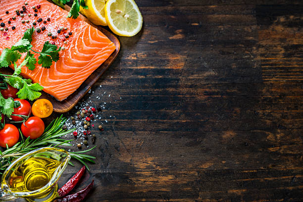 istock Raw salmon fillet border on dark table. Copy space 1222257022