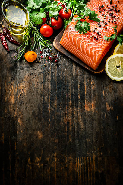 istock Raw salmon fillet border on dark table. Copy space 1222257023