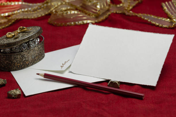 istock Artistic template for invitations and greetings. Card on a red background, envelope, ribbon, paper. 1222257156