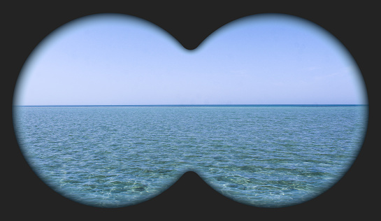 Sea view through binoculars. Seascape view via the field-glass.