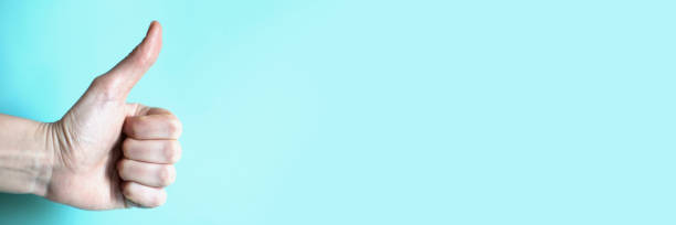 istock Gesture thumbs up on the blue background 1222257871