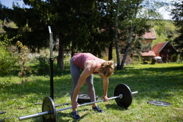 istock A young woman lifting a barbell weight 1222258867