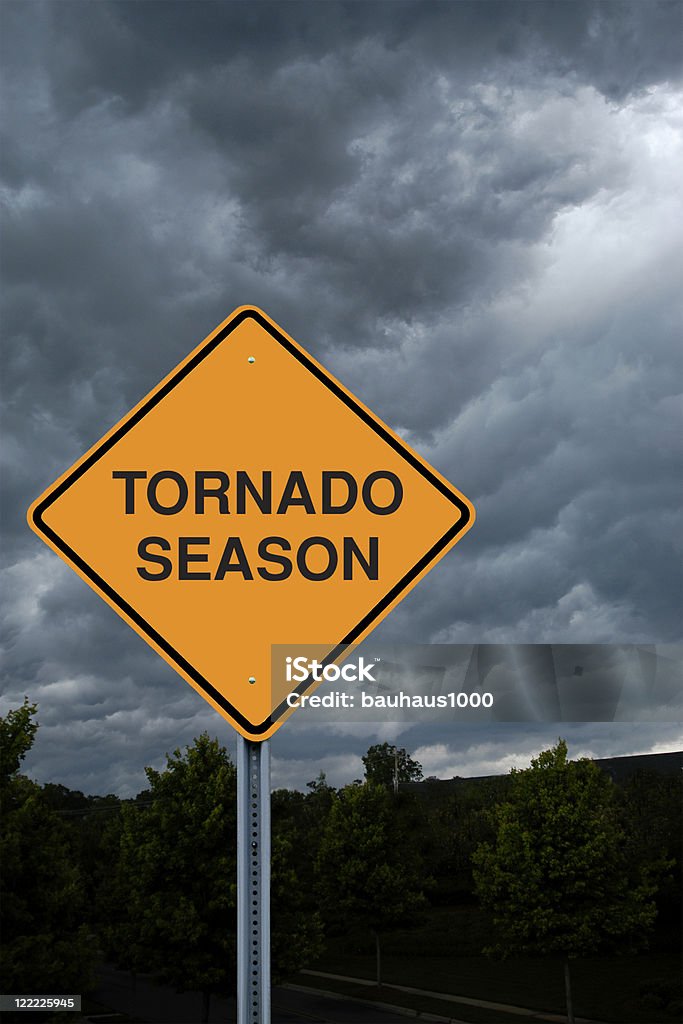 Warning Sign in Front of Storm Clouds A Warning Sign in Front of Storm Clouds Warning of Tornado Season Cloud - Sky Stock Photo