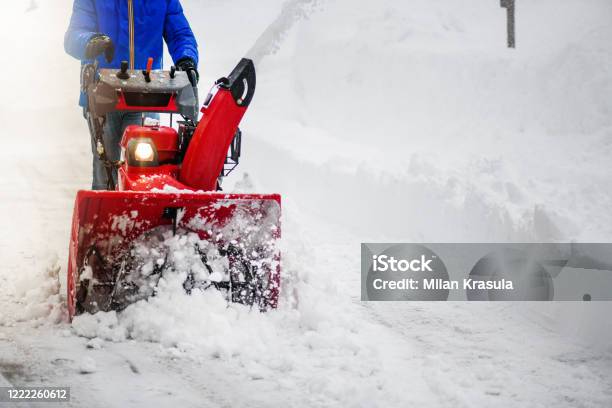 Man Clearing Or Removing Snow With A Snowblower Stock Photo - Download Image Now - Snow, Snowblower, Snowplow