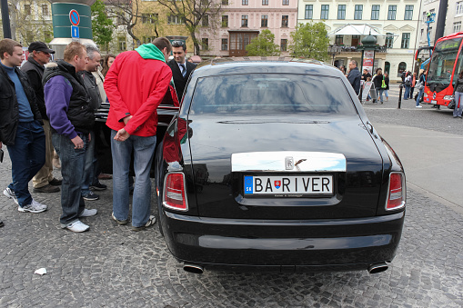 Bratislava, Slovakia - April, 2011: people look on black Rolls-Royce Phantom.