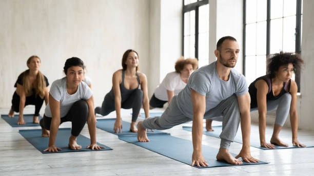 istock Diverse people performing Low lunge forward or Ashva Sanchalanasana indoors 1222262388