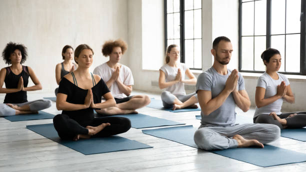 istock Seven diverse people folded hands Namaste symbol meditating indoors 1222262461