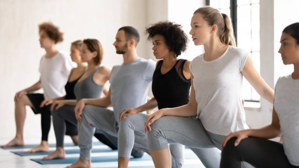 istock People doing low lunge with knee grip warming up body 1222262924