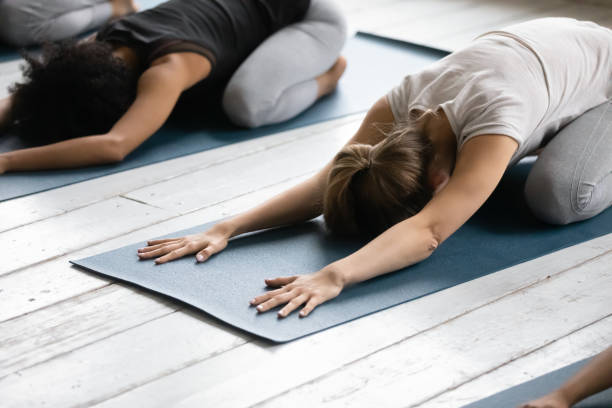 istock Women practicing Child Pose reducing fatigue after workout close up 1222262933