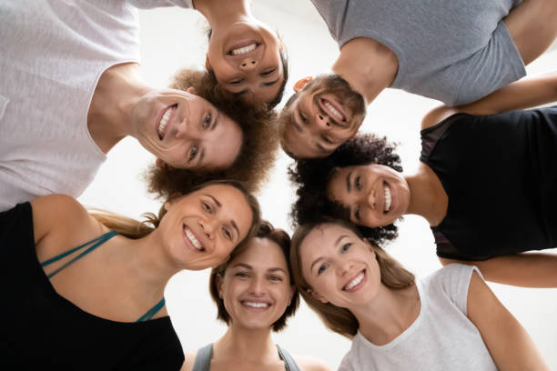 istock Multiethnic people standing in circle leaned to look at camera 1222262969