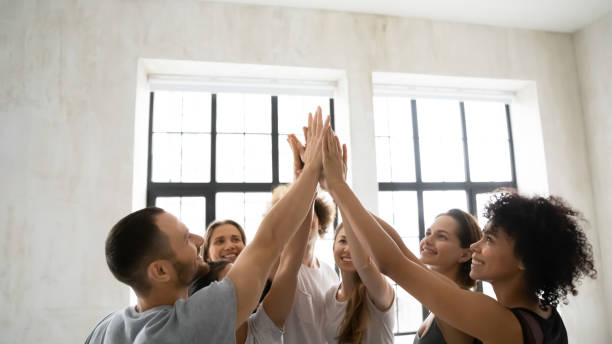 istock Group of sporty multiethnic people giving high five showing unity 1222262979