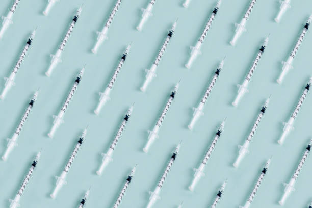 Syrince. Syringe pattern on blue background with copy space. tetanus photos stock pictures, royalty-free photos & images