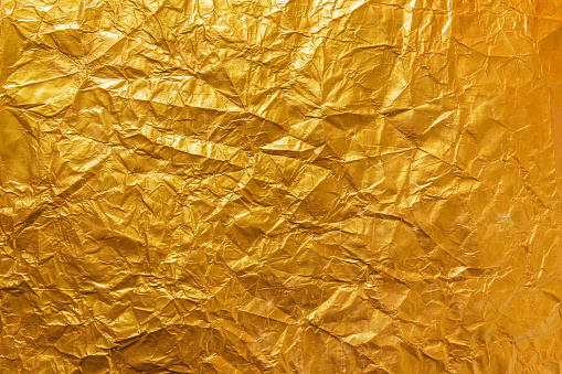 Crumpled artistic gold background.