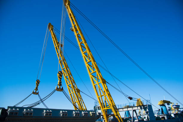 istock Loading in port. Floating port crane on blue sky background 1222265182