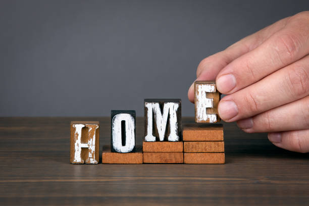istock HOME concept. Wooden alphabet letters on steps 1222266213