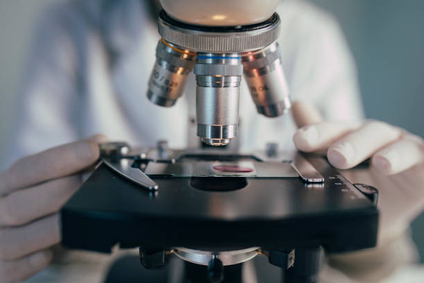 istock Microcsope Lenses and a Glass Slide With a Sample in Close Up 1222266576