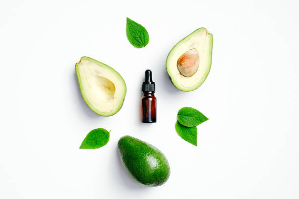 istock Fresh avocado and essential oil bottle on white background. Flat lay, top view. SPA natural organic cosmetics, eco beauty product for skin care and hair treatment 1222266826