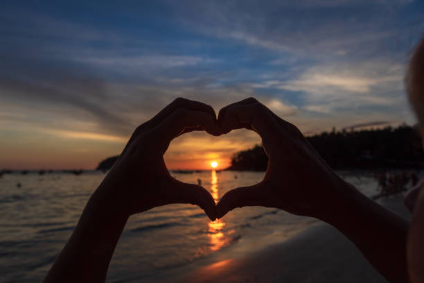 istock hands forming a heart shape with sunset silhouette 1222270516