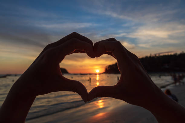 istock hands forming a heart shape with sunset silhouette 1222271819