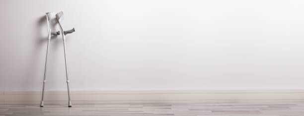 istock Two Crutches Leaning Against Concrete Wall 1222271883