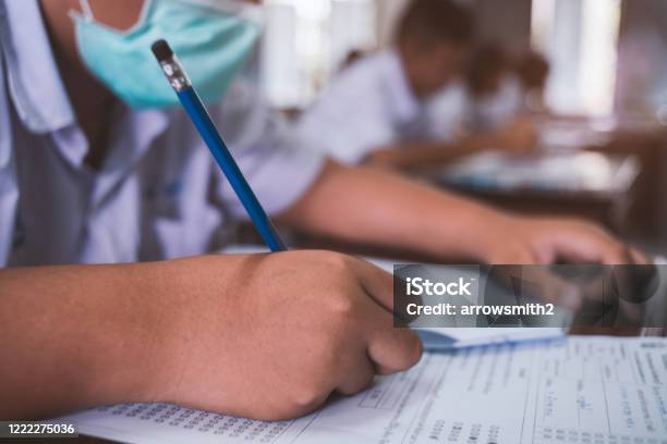Students Wearing Mask For Protect Corona Virus Or Covid19 And Doing Exam In Classroom With Stress Stock Photo - Download Image Now