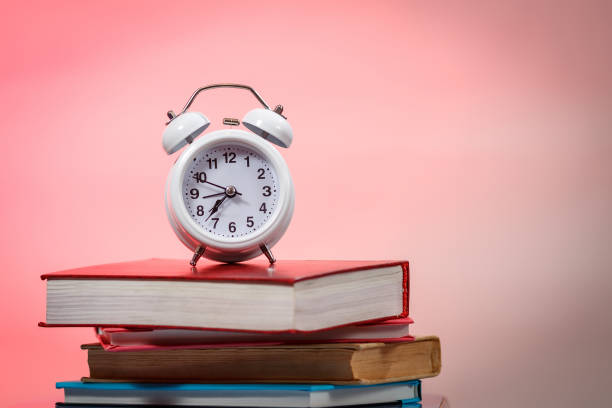 istock Alarm clock stack of books table. Education concept. 1222275947