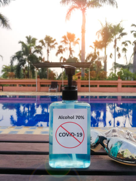 Alcohol 70% Sanitizer standing side of the swimming pool for protect corona virus or covid-19 stock photo
