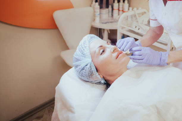 istock Cosmetology doctor makes injection in the lips 1222277750
